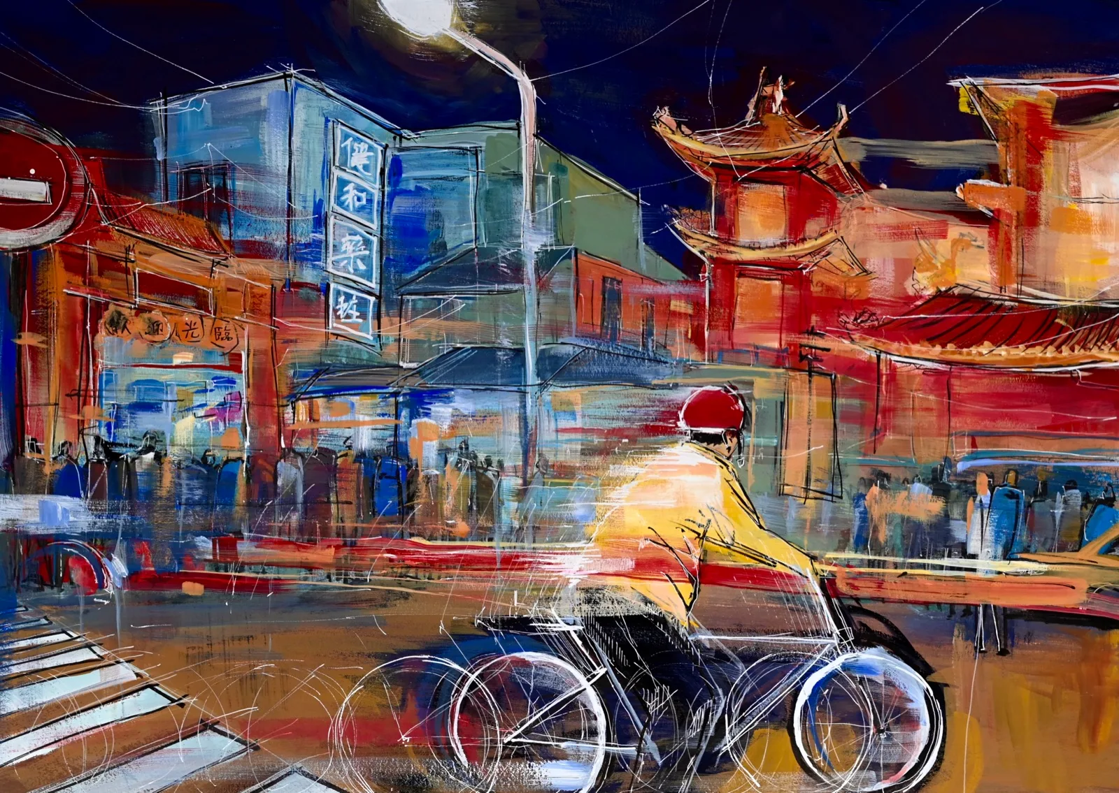 A cyclist in a yellow jacket riding past a red temple and market buildings at night